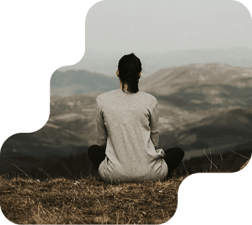 Person sitting peacefully in nature